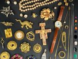 many different types of jewelry on a black surface