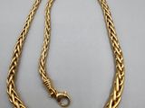 a gold chain with a clasp on a white background