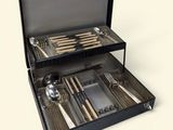 un coffret noir contenant de l'argenterie, sur fond blanc