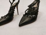 pair of black high heeled shoes with studded straps