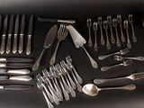 a lot of silver spoons and spoons on a table