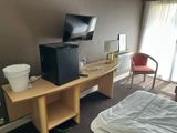 a small television on a desk in a hotel room