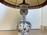 a lamp that is sitting on a table with a lamp shade on it