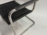 an image of a black leather and chrome chair on a white background