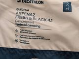 a close up of a blue and white sleeping bag on a bed