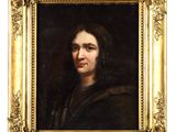 un tableau représentant un homme en manteau noir, dans un cadre doré