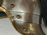 a close up of a helmet with a horse ' s hair on it