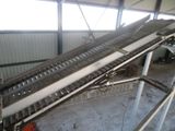 a conveyor belt in a warehouse with a conveyor belt