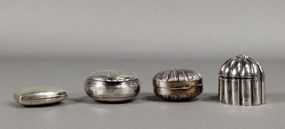 three silver objects are sitting on a table next to each other