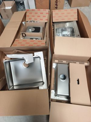 many boxes of different types of kitchen appliances in this room