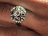 a close up of a person ' s hand with a ring on it