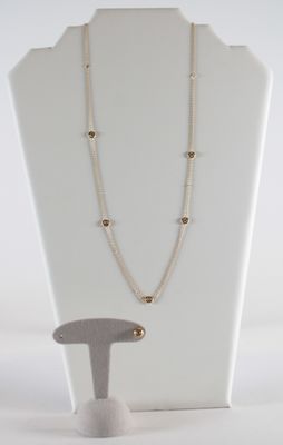 ensemble collier et boucles d'oreilles présenté sur un mannequin blanc