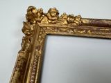 a picture of a gold frame on a white wall