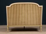 an image of a bed with a striped headboard and foot board