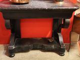 une table noire sur laquelle est posé un faitout