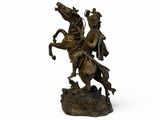 bronze statue of a man on a horse with a sword