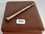a brown box with a pen on top of it