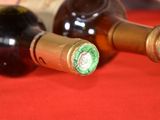 two bottles of wine sitting on a red cloth