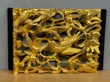 a gold plate with birds on it on a table