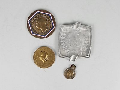 three coins and a coin sitting on a white surface