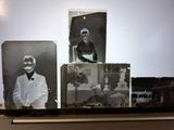 several old black and white photos of a man in a tuxedo sitting on a table