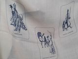a white scarf with a picture of people and animals on it