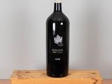 a bottle of wine sitting on top of a wooden box