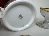 a white and gold cup and saucer on a table
