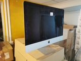 a computer monitor sitting on top of a box in a room