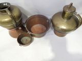 three pots that are sitting next to each other on a table