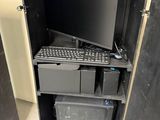 a computer that is sitting inside of a metal cabinet