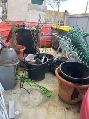a lot of garbage on the ground next to a fence