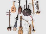 many musical instruments that are arranged together on a white surface