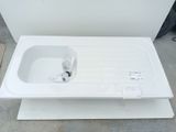 a white sink sitting on top of a white box