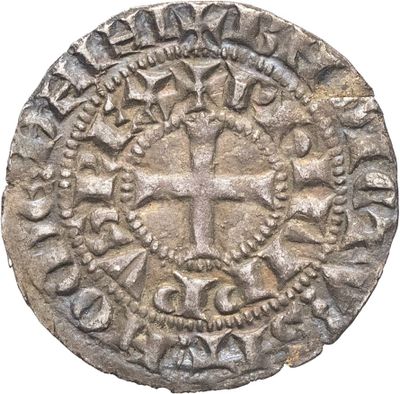 une vieille pièce d'argent ornée d'une croix
