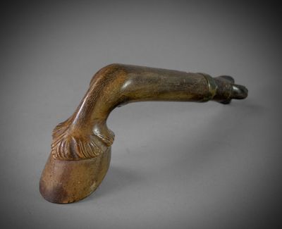 a close up of a pipe on a table with a gray background