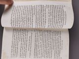 an overhead view of a person reading a book on a table