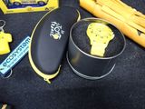 a yellow watch sitting in a black box next to other items