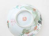 a white bowl with a dragon on it on a table