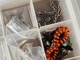 many different types of jewelry in a white box