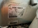 a label on the back of a machine that is sitting on the ground