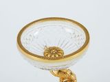 a glass bowl with a gold decoration on it