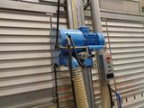 a blue blow dryer sitting on the side of a building