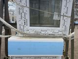 two microwaves stacked on top of each other on a pallet