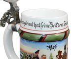 a beer mug with a handle that is decorated with a picture of a horse and rider