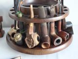 many different types of pipe holders on the table