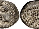 a silver coin with an image of a woman on it
