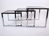 three chrome and glass nesting tables on a white background