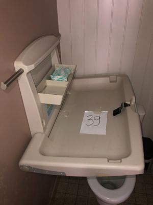 a toilet with a sign on it in a small bathroom