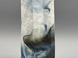 sculpture of a whale in the ocean with clouds in the background